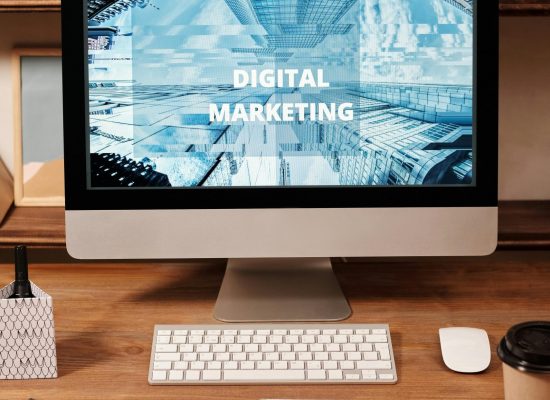 Contemporary office setup featuring digital marketing strategy on a computer screen, ideal for business technology themes.